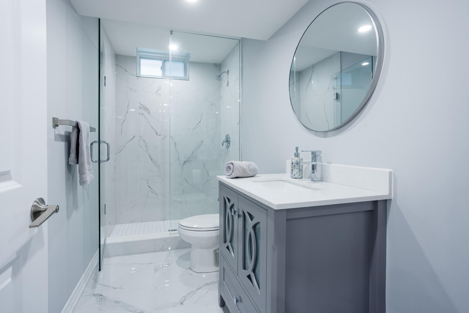 grey theme bathroom renovation with grey painted wall with matching vanity