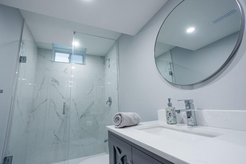 round bathroom mirror with shower glass door