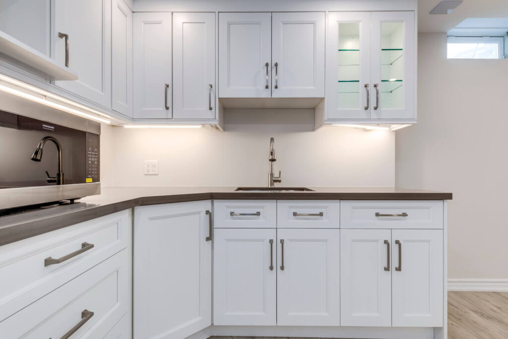 classic white basement kitchen renovation with cabinets and countertop