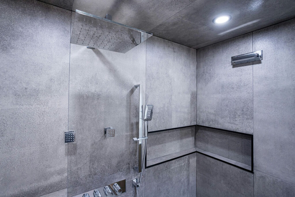 natural marble tiled walls and floor with wall built in shelf