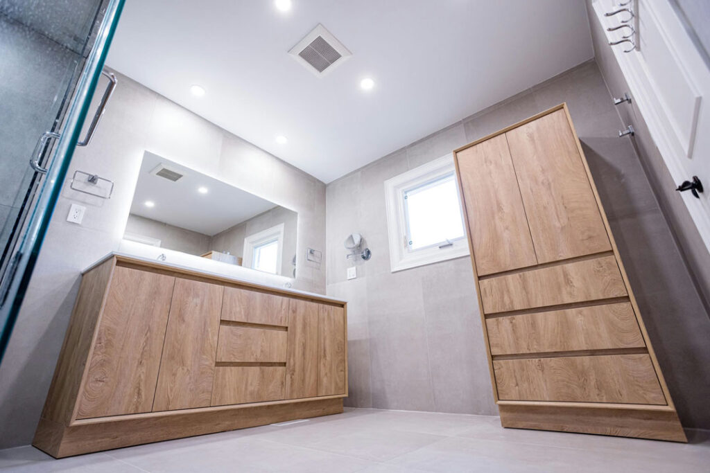 luxury bathroom renovation with glossy non slip flooring and painted walls with wooden vanity and cabinet