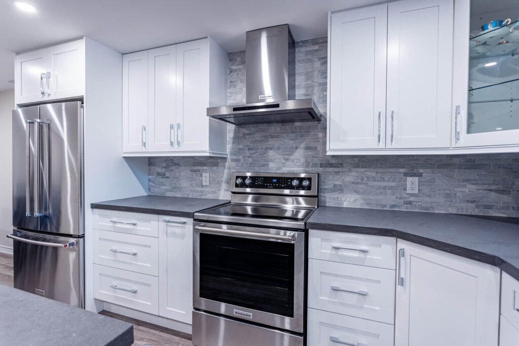basement small kitchen white cabinets with countertop and tiled wall