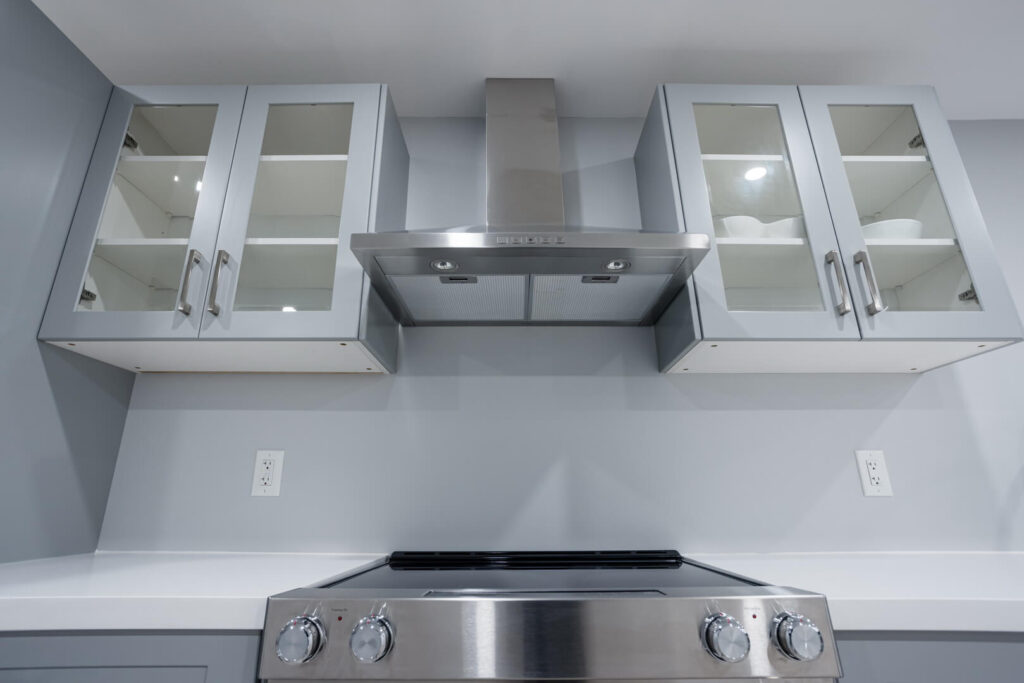 glass door cabinets with painted kitchen wall
