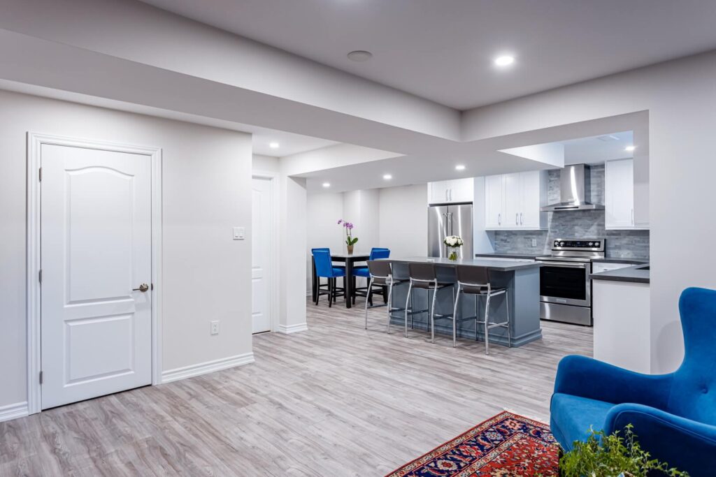 large basement kitchen renovation with island, cabinets and countertop