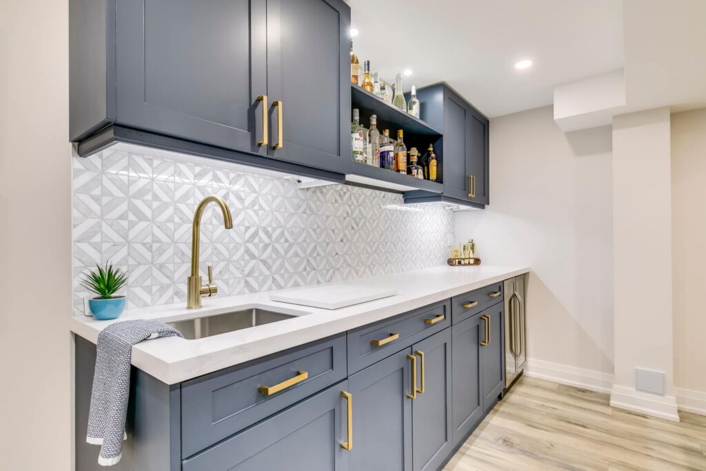 elegant grey cabinet with golden handles and white countertop with tiled wall