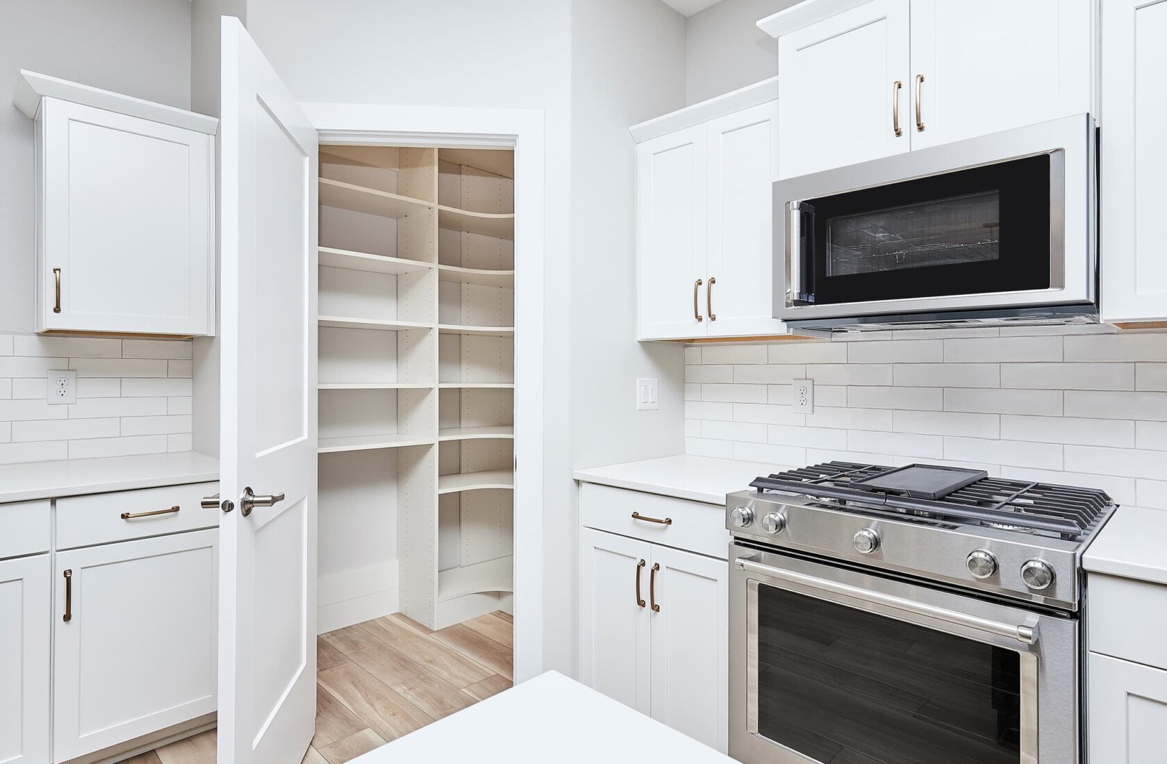 kitchen pantry closet for extra storage with white cabinets and countertop