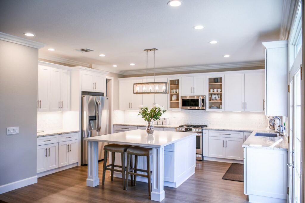 centre installed white island with white cabinets with ceramic countertop