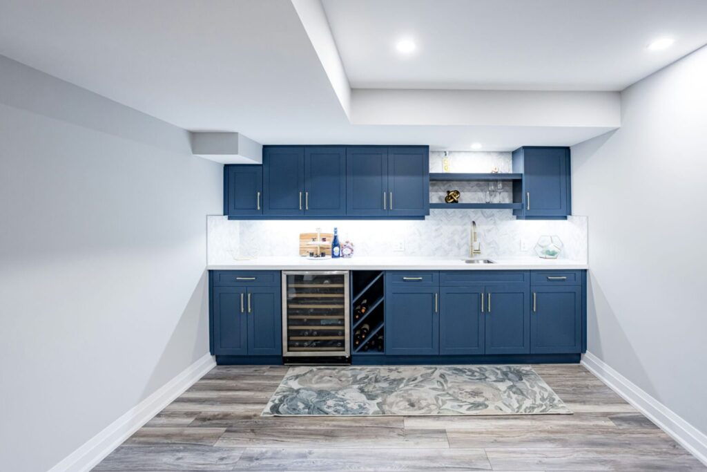 blue cabinets with white tiled wall and countertop
