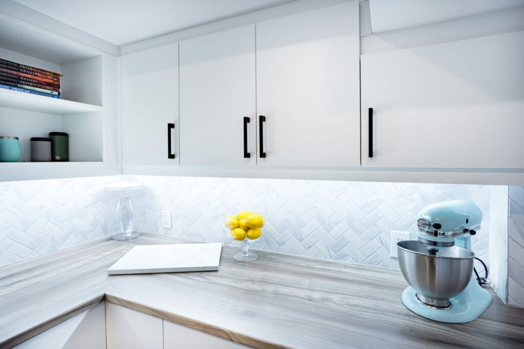 white kitchen cabinets with wooden countertop