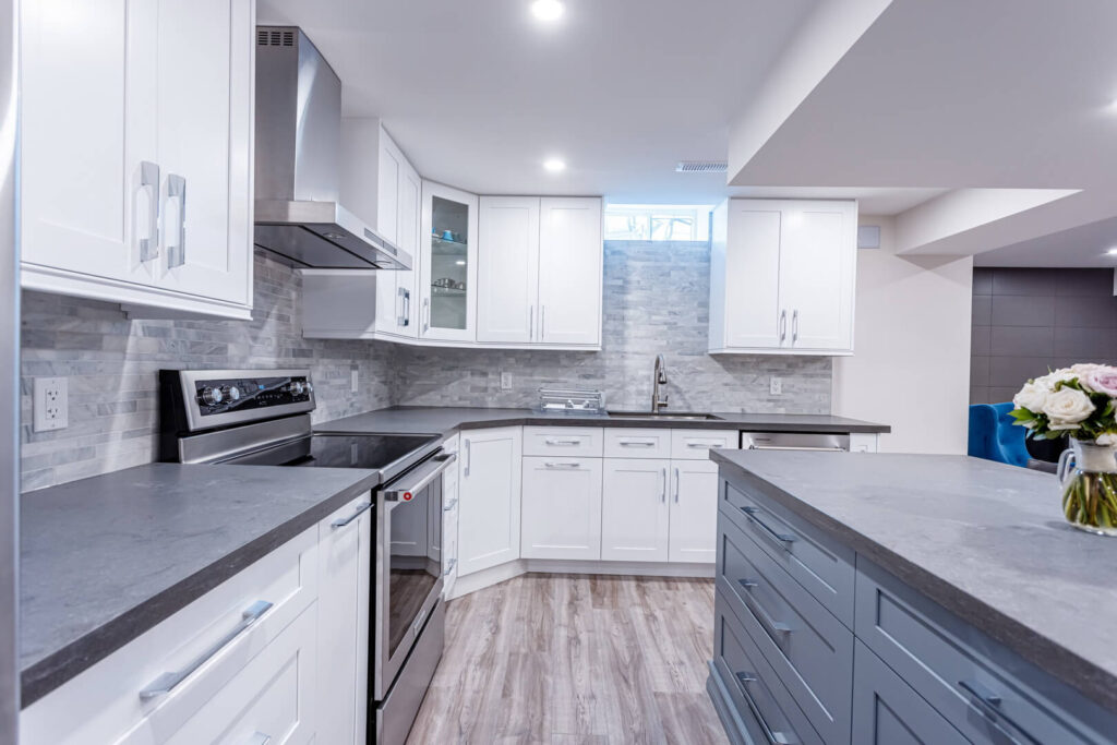 island installed with drawer and extra storage space cabinets with grey countertop