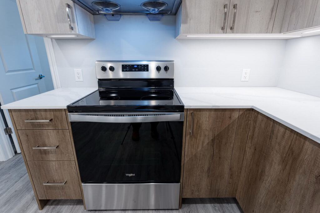 kitchen white countertop with brown cabinets and cooktop