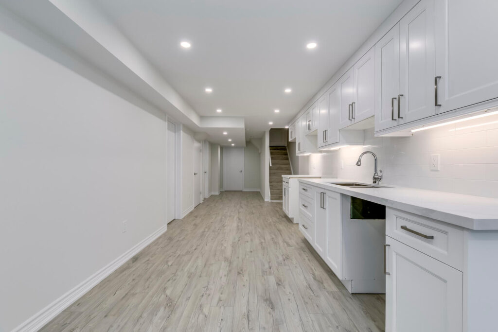white custom cabinets installed in basement kitchen