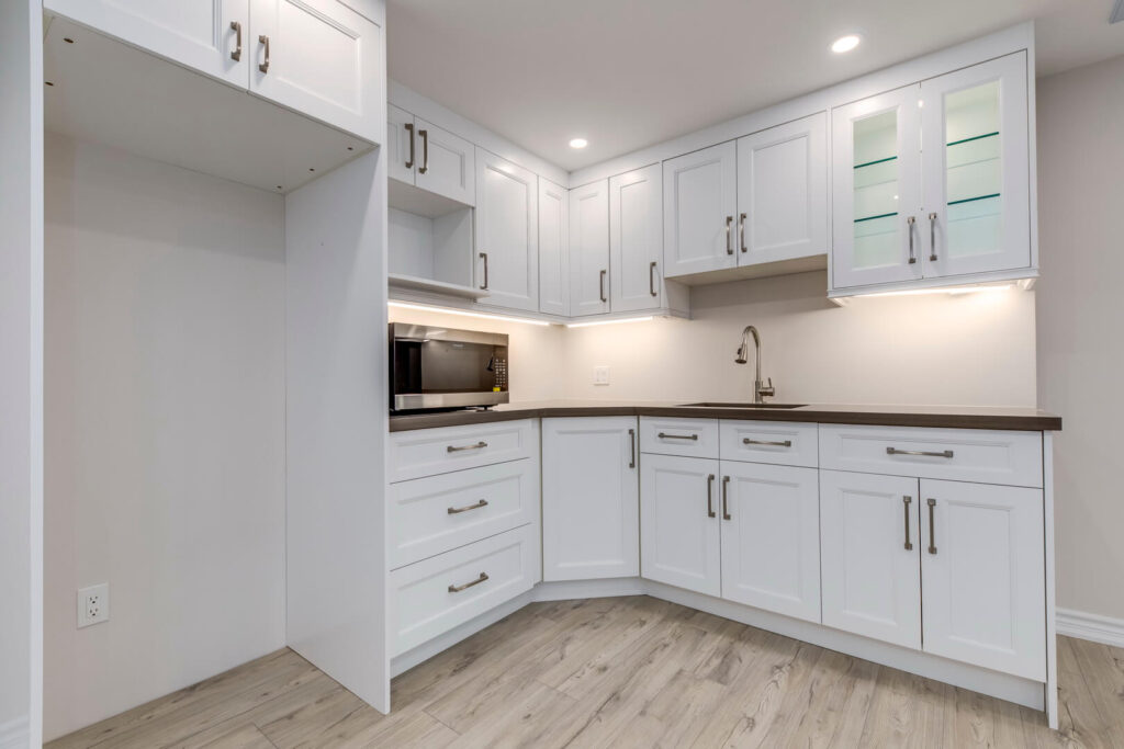 white cabinets with rose gold hardware and kitchen flooring
