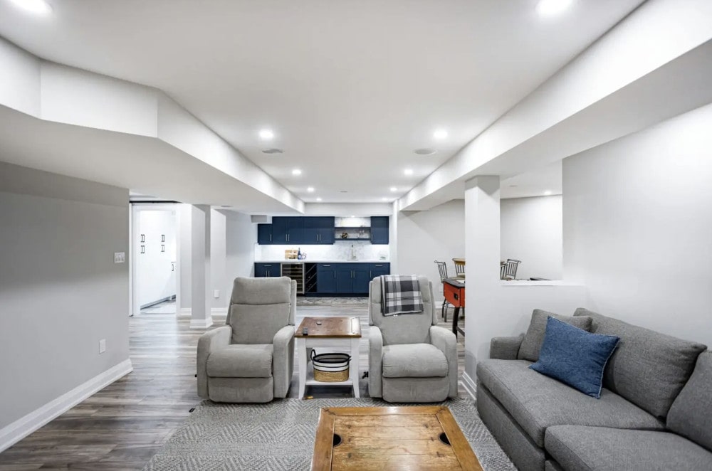 How to Save Money on a Basement Renovation: Finished basement with kitchen and living zone