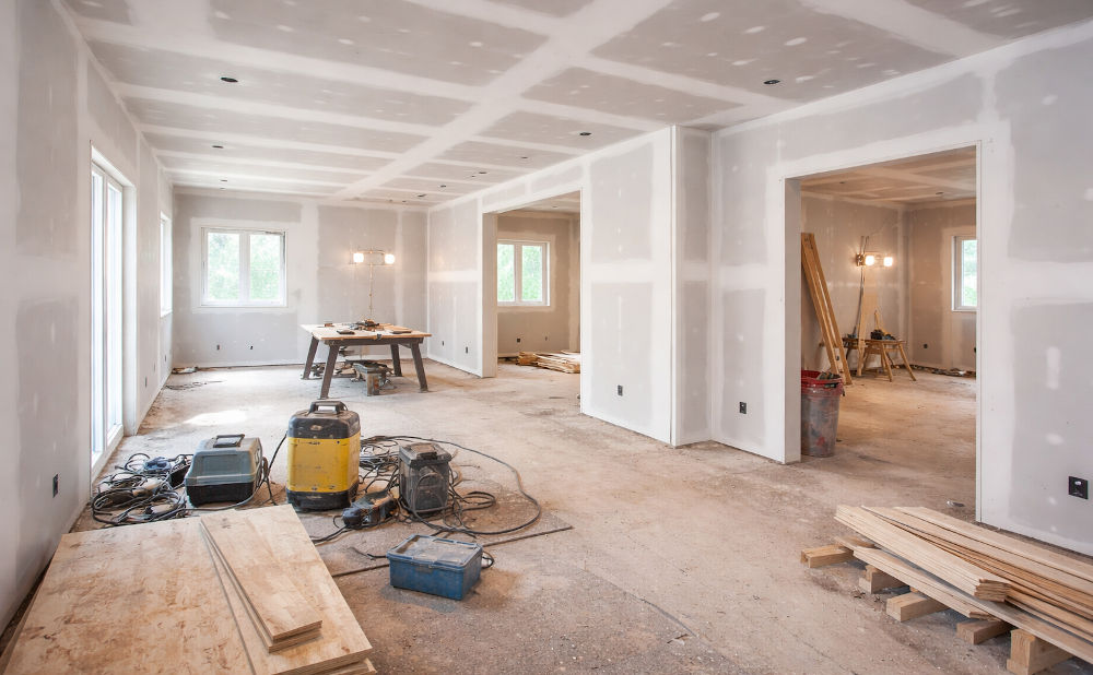 Interior home renovation stripped to studs showing substantial renovation work